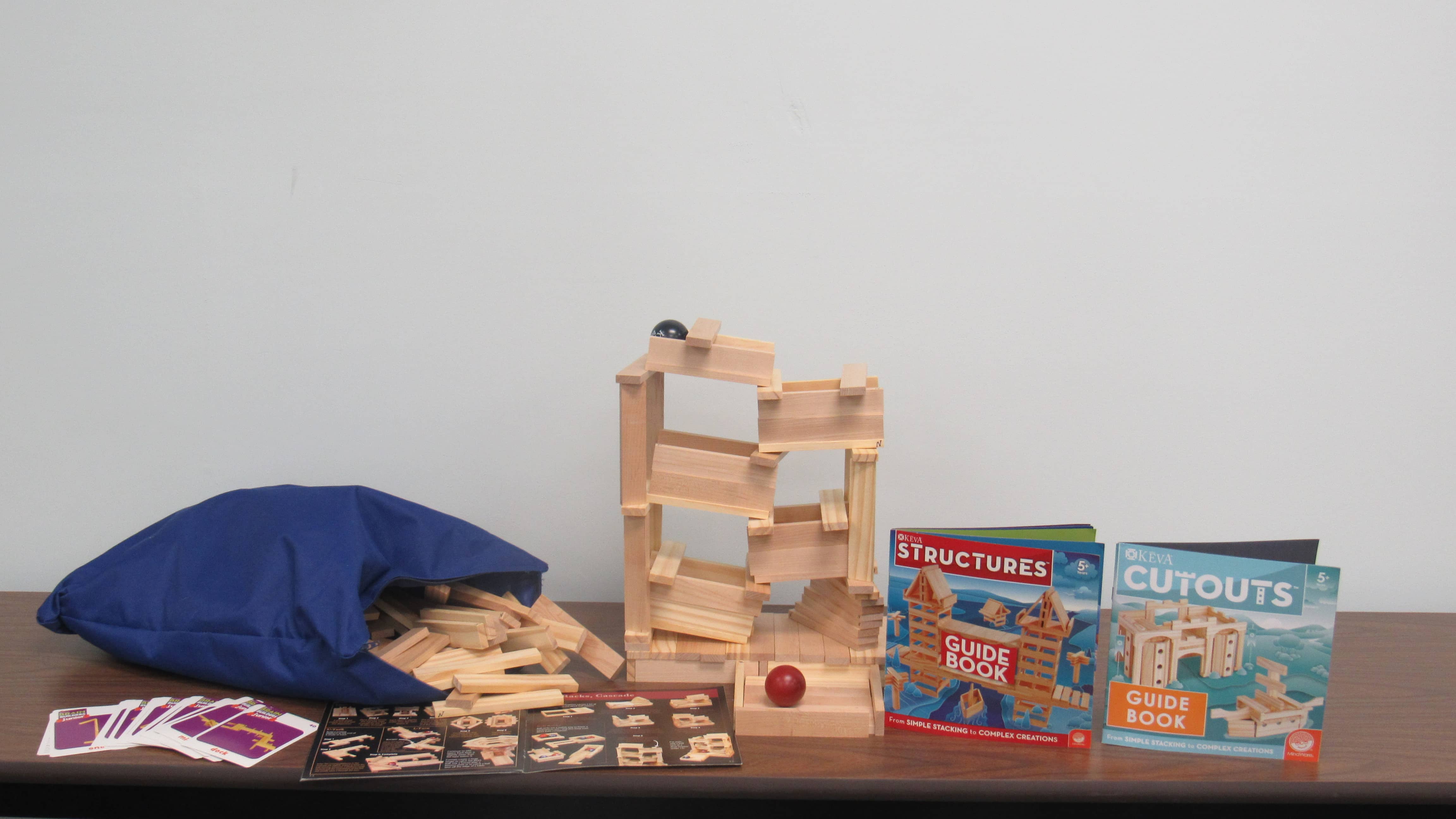 Pieces of Keva block engineering kit laid out on a table