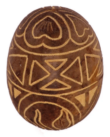 A brown egg-shaped shaker with tan designs patterned on it