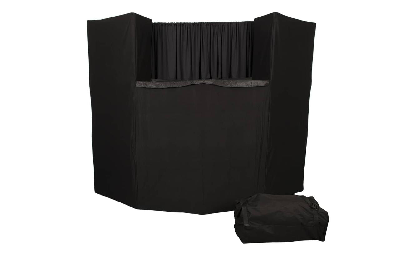 A black puppet theater with the bag it travels in next to it