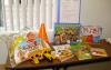 Contents of Play Early Literacy Kit including books, construction toys, and a construction worker dress-up set