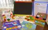 Contents of the Write Early Literacy Kit including books, a chalkboard, and stacking blocks